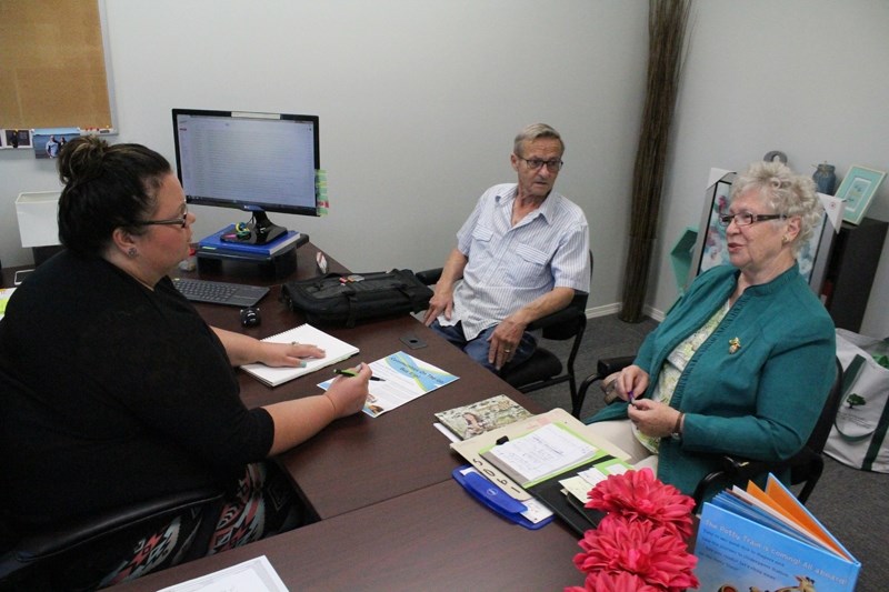 Shirley Thompson, right, meets with Jolene Sanford of Didsbury Neighborhood Place and Bob Krottner last month to talk about community bus scheduling.