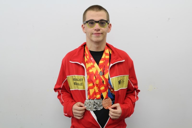 Wesley Wilks of Didsbury poses with the four medals (three silver, one bronze) he won at the Canada Summer Games for Special Olympics swimming last week in Winnipeg.