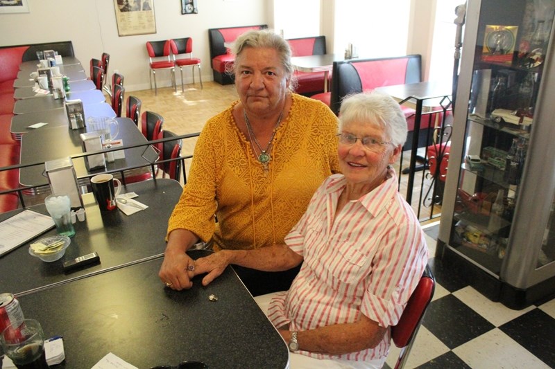 Anne-Marie Day, left, and Shirley Dorin share a coffee at a local restaurant in Didsbury. Day found the ring – seen here on the table – that Dorin had lost at the Didsbury