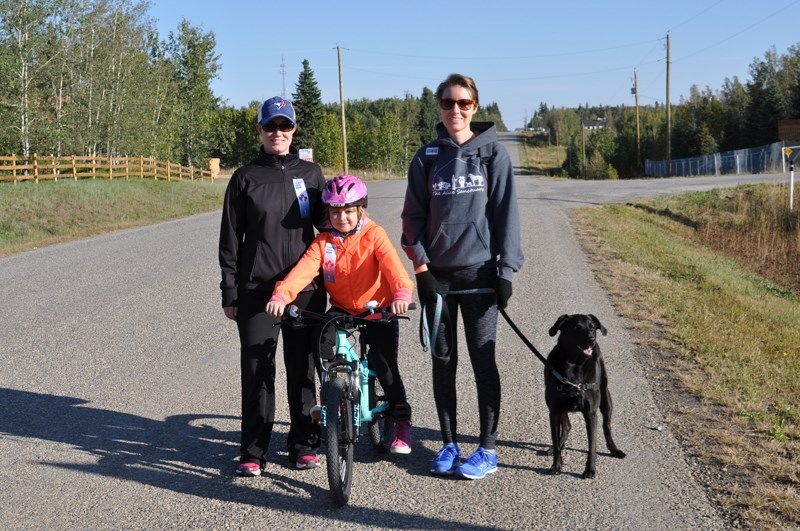 Meagan Shapka, left, Callie Shapka and Carmen Croft take part in the 2017 Water Valley Terry Fox Run.