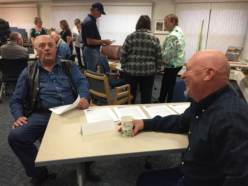 Mountain View County resident Wayne Keiver, left, visits with Reeve Bruce Beattie at the Oct. 5 candidates meet-and-greet at the Sundre Library.