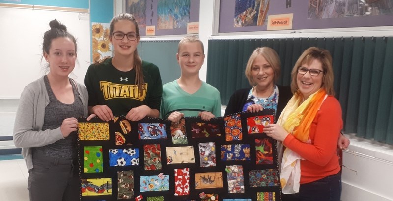 On Dec. 6, members of the 4-H Multi Club presented a community quilt they made to the McMan centre, which works with children and families who need help. From left, club