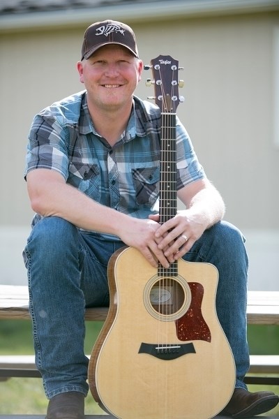 Dustin Farr holds a guitar at his Westerdale home.