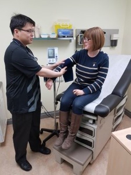 Dr. Charles Wang checks the blood pressure of Leanne Hooper during the open house Oct. 7 at the newly opened Snowy Owl Medical Clinic in Carstairs.