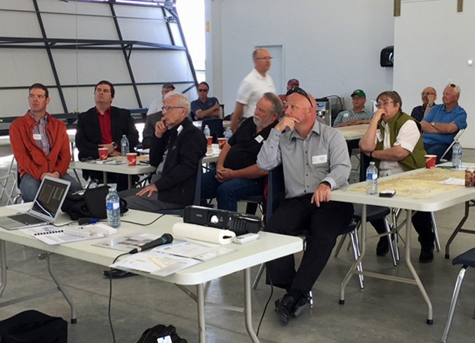 Guests listen to an address by Greg Neufeld during the recent airport tour.