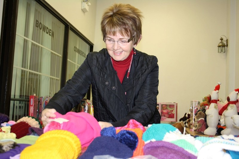 Norma Hoppins sorts through toques and mitts at the Christmas Bureau Dec.9. The Bureau saw a record number of people utilize its services this season.