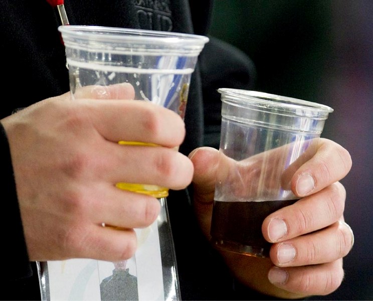 Fans buy beer during the Continental Cup at Servus Credit Union Place. A new study suggests that up to eight per cent of fans leaving pro sports games are drunk.