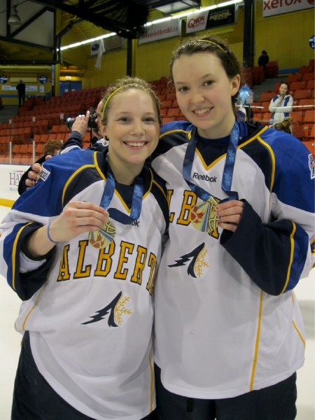 Team Alberta gold medalists Hannah Mousek of Olds and Innisfail&#8217;s Taryn Baumgardt show off their Canada Winter Games gold medals that they and their teammates won by