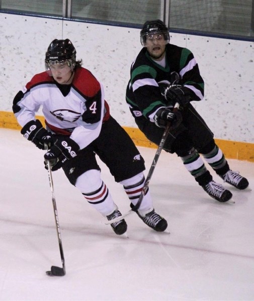 Eagles No. 4 Carl Bjorge skates the puck around the net away from opposing Rams player as the Innisfail Eagles play the Rocky Rams in an exhibition game on Friday, Feb. 25.