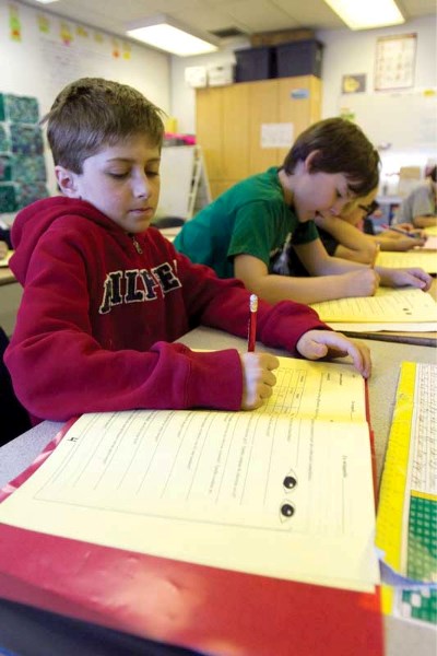 Students from Mme. Karine Boissonneault-Empey&#8217;s Grade 3 French Emersion class at St. Marguerite Bourgeoys Catholic School work in their classroom on Friday, April 15.