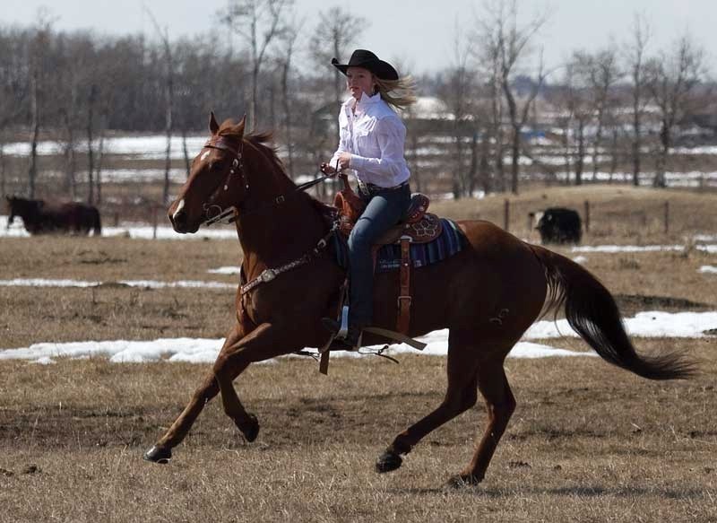 Sydney Daines rides her families registered quarter horse Flame on their farm just east of Innisfail.