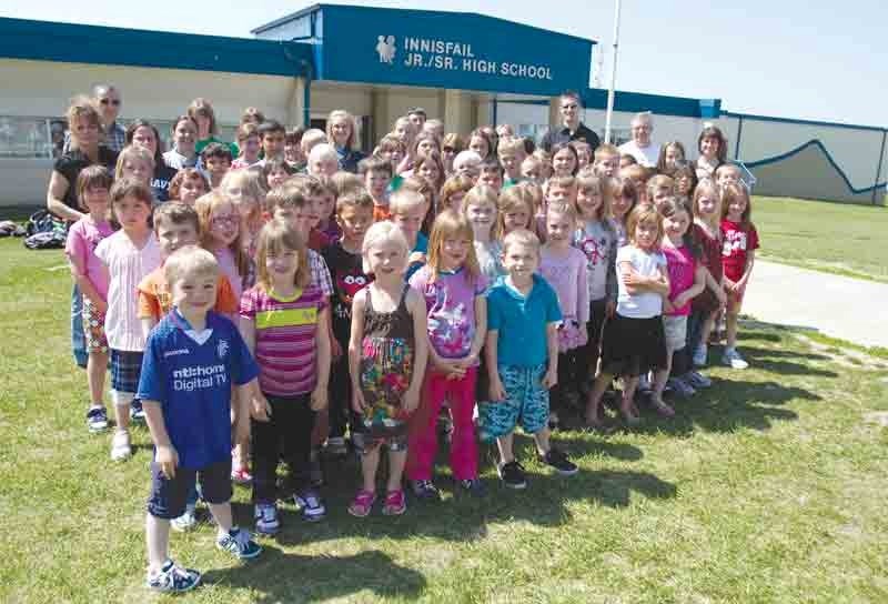 The French Immersion students from école John Wilson Elementary School and Innisfail Middle School stand with their teachers and principals in front of Innisfail Junior