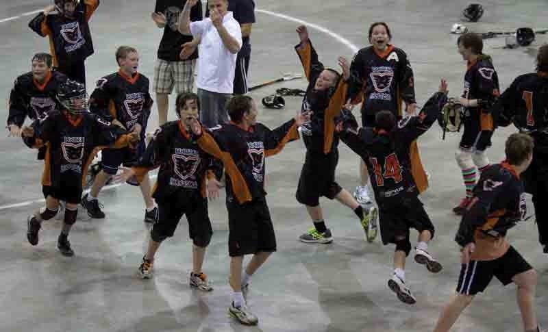 Players from the Innisfail Pee Wee Servus Credit Union Phantoms celebrate after winning gold over the Red Deer Rock in the Spirit of the Sticks Tournament in Innisfail over