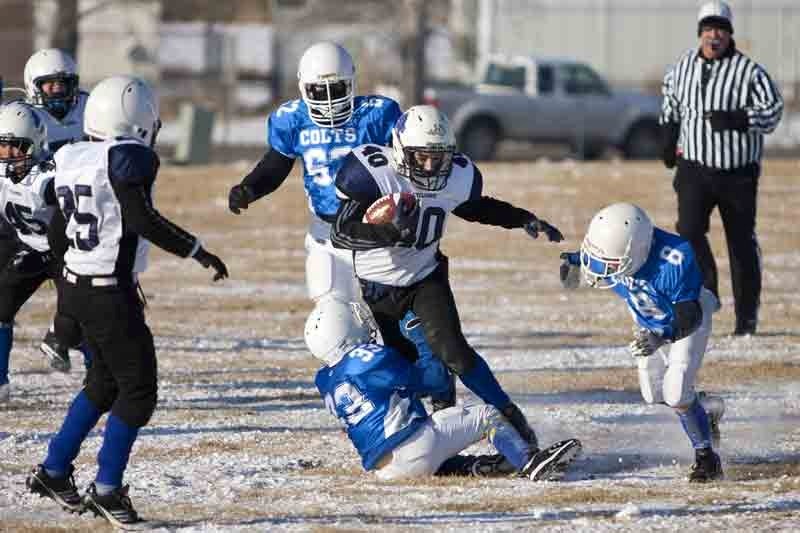 Innisfail Cyclones player Cole Martin is tackled by a South Calgary Colts player during their game in Innisfail last Saturday. The game was for the Alberta Provincial