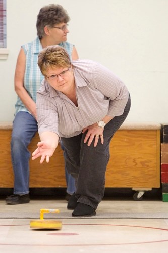 Norma Jameson plays a game of floor curling at the Innisfail Senior Drop-In Centre last Thursday.