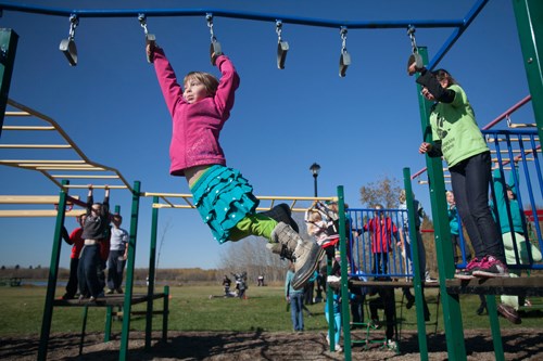 Children play on a playground at Centennial Park during a cross country event on the morning of Oct. 4.