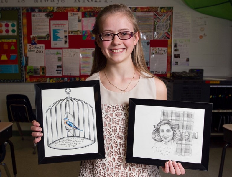 Innisfail Middle School student Ashley Arthur with some of her artwork at the school on April 4.
