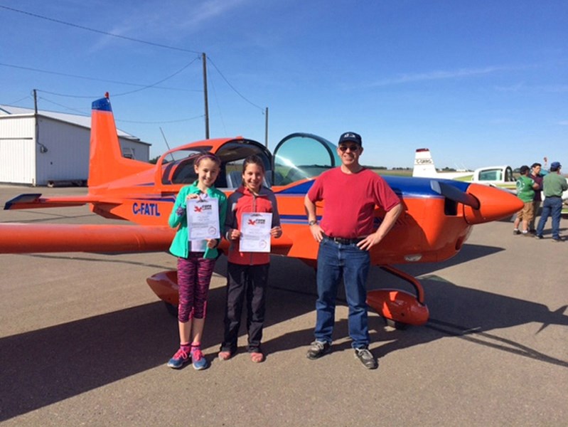 The COPA For Kids flight day is taking place April 29 at the Innisfail Airport. Hope Jacobs and Maisyn Petryshen of Innisfail, pose with their pilot during last year&#8217;s
