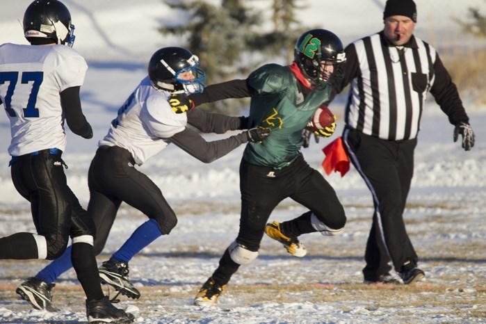 Bowden Blazers player Brandon Rude attempts to shed a tackle from a Buck Mountain Mustangs player during the teams&#8217; championship game in Bowden on Nov. 26. The Mustangs 
