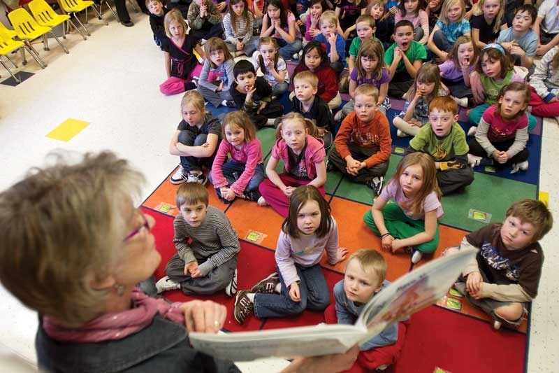 Students from Chinook Centre School listen to kindergarten teacher Catherine Wagner read a story during their Friday afternoon group activities on March 11.