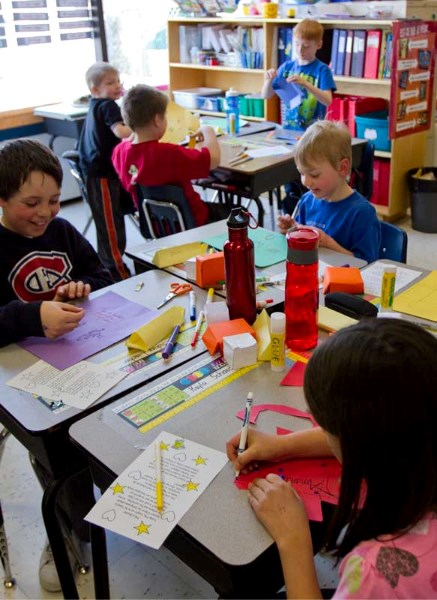 Students from Chinook Centre School make paper buckets on March 11 during their Friday afternoon group activities. The students took their buckets home so they could continue 