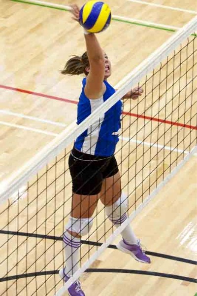 Innisfail Cyclones player Brittany Bovey spikes the ball during the Cyclones game against the Buck Mountain Central School Mustangs at a tournament hosted by Olds College at