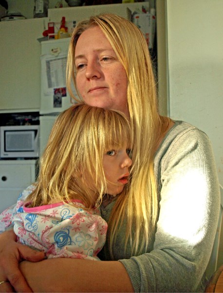 Robin Brand holds her five-year-old daughter Brooke, who is dying from Batten disease.