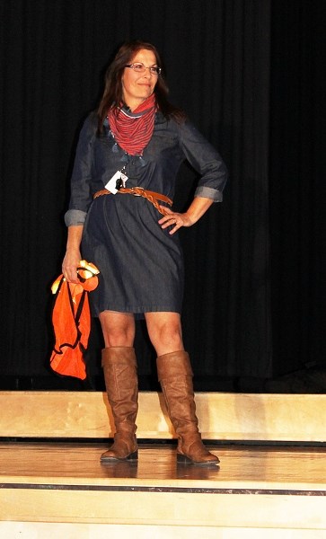 Debbie Rieberger, educational assistant at John Wilson Elementary School, strikes a pose just after playfully scolding students for misbehaving on the fashion show stage on