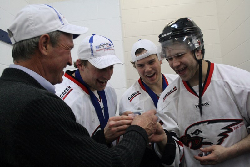 Brian Sutter celebrates the 2013 Senior AA victory with Eagles players after the finals April 7.