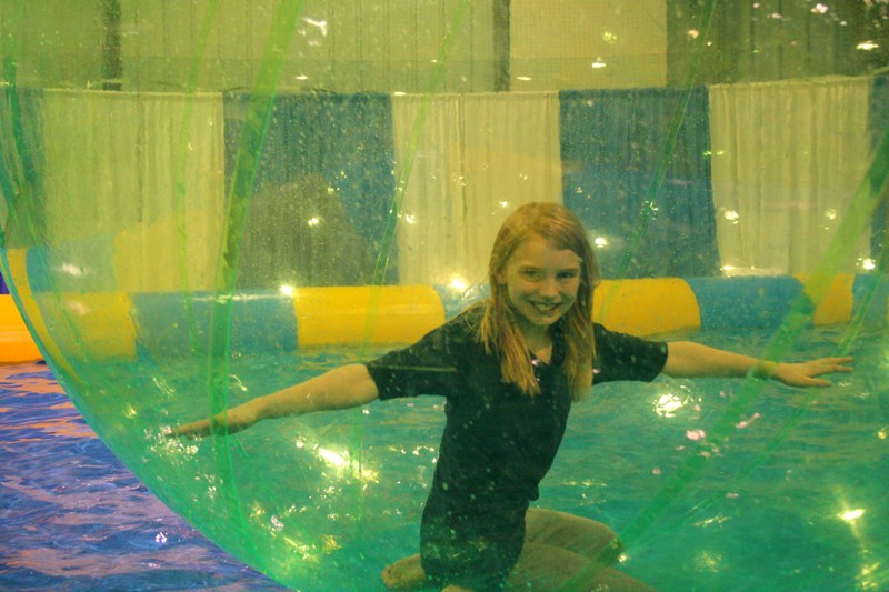 Madeline Black tries to balance while inside a Bubbleswild water ball at the Innisfail Trade and Leisure Show April 20.