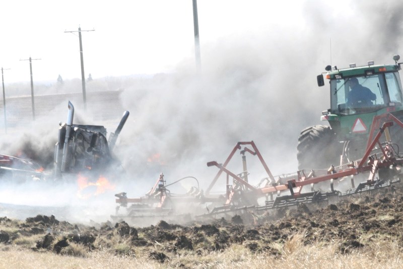 A farmer creates a barrier so fire from a deadly car accident won&#8217;t spread across the surrounding fields.
