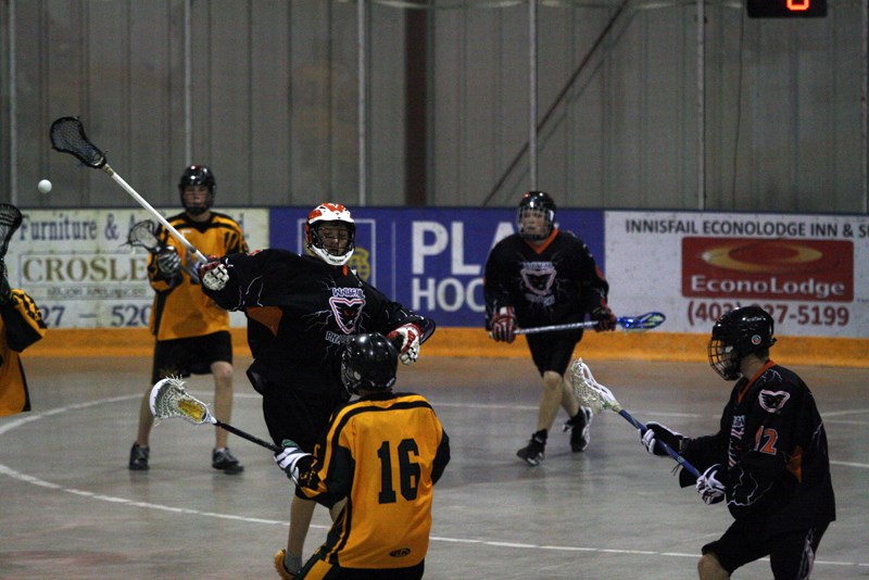 Midget Phantoms player Kaden Christensen puts up a defensive wall against a Sherwood Park Titians opponent.