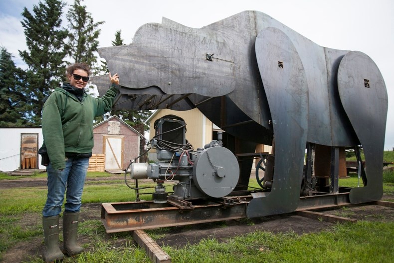 Kaitlin Van Zandt, zookeeper at Discovery Wildlife Park, in front of the new huge animated grizzly bear, possibly a world record holder. It is expected to be unveiled to the