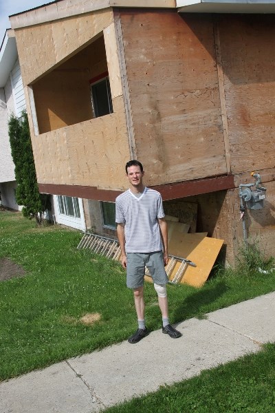 Joshua King stands outside the house where he rescued two young boys from during a raging fire.