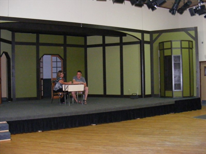 Co-directors Kim Norlin and Shane Hauser discuss ideas for their upcoming play on the large, newly constructed set. The size and intricacy of the set was possible due to the