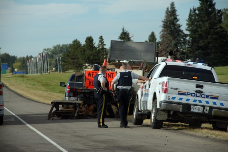 Bowden Fire Department and Innisfail RCMP probe the wreckage following the car accident that occured Aug. 29.