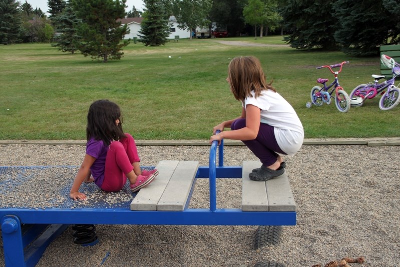 Sophie (left) and Olivia Bergeron play at Raspberry Park. Following the gang beating of Aidan Remple, parents of the neighbourhood say they are going to keep a much closer