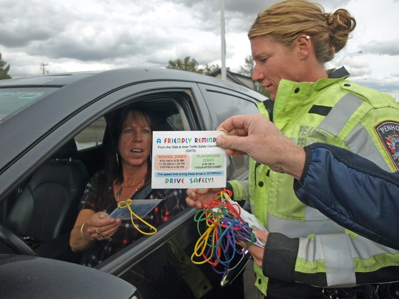 An Innisfail driver is presented with a special message card by Penhold peace officer Dana Jones during last week&#8217;s Speed Awareness Campaign held throughout central