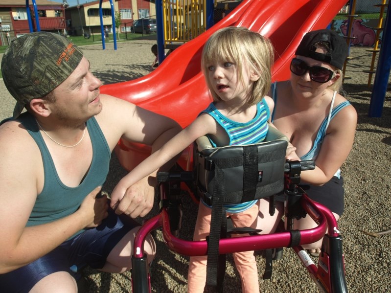 Five-year-old Brooke Aubuschon with her parents at an Innisfail park.