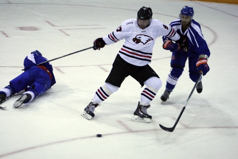 Innisfail Eagles &#8216;AAA&#8217; player Kevin Smyth battled the Okotoks Diller &#8216;AA&#8217; senior boys team for the puck during a home game on Oct. 18.