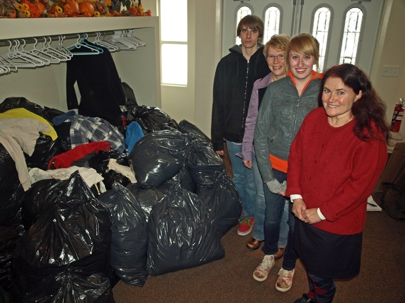 Innisfail schools and churchs joined together to help Syrian civil war refugees brave the upcoming winter by collecting sweaters, hoodies and other clothing. From left to