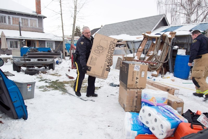 Members of the Olds RCMP remove as much as $40,000 in stolen goods from a 51 Street home on the afternoon of Nov. 8. The recovered items were stolen from homes and businesses 
