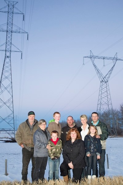 Angry locals over AltaLink&#8217;s plan include, from left, Harvey Lind, Ruth Lind, Chris Thompson, Jacob Stauffer, Rob Davis, Kim Thompson, Manuela Wachter, Shannon Wachter