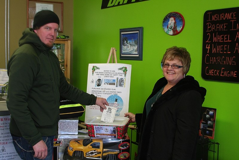 Diane Mineault, the executive director of the Innisfail and District Chamber of Commerce, is all smiles as a shopper enters the Santa&#8217;s Sleigh contest at Innisfail Tire 