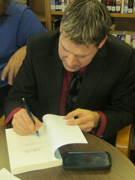 Author William Boulton signs copies of his book, I Miss Me, recently at the Elnora Public Library.