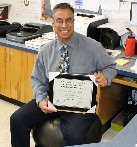 Narsh Ramrattan, vice principal of Innisfail Jr./Sr. High, holds his North American Biology Teacher Association Award for Western Canada.