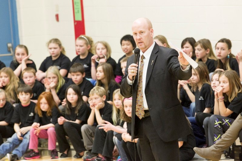 Jeff Johnson, the provincial minister of education, tells students and staff at école John Wilson Elementary School about the government&#8217;s decision to spend up to $12