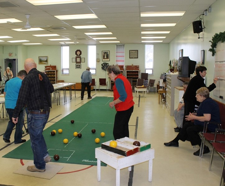 A group of Innisfail seniors play an end of floor curling at the Seniors Drop-In earlier this month.