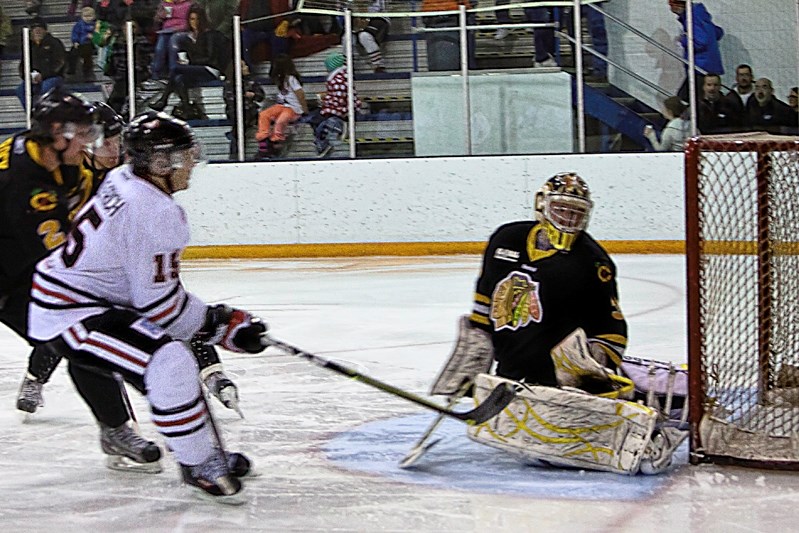 The Eagles&#8217; Tyler Helfrich fires a shot from close in past Fort Saskatchewan goalie Jim Watt in the second period to tie the game 3-3.