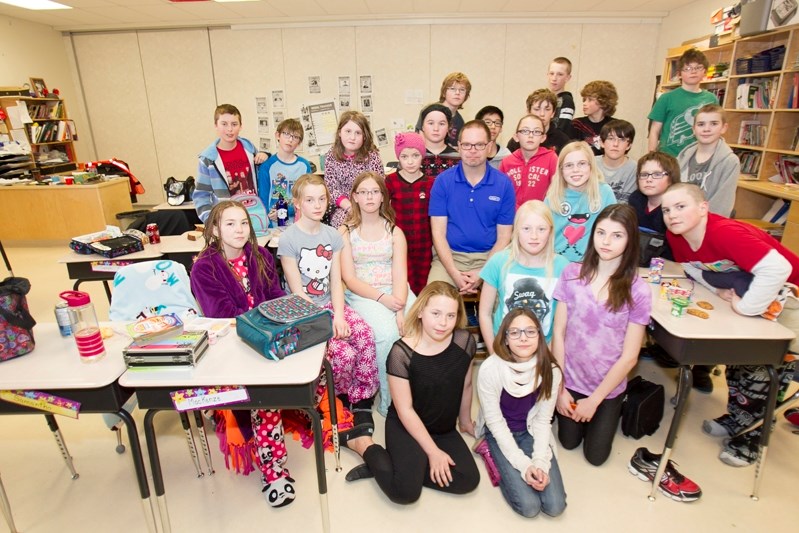 Innisfail Middle School teacher Tom Stones gathers with his Grade 6 class, the same group of students who attended the raucus question period last fall.